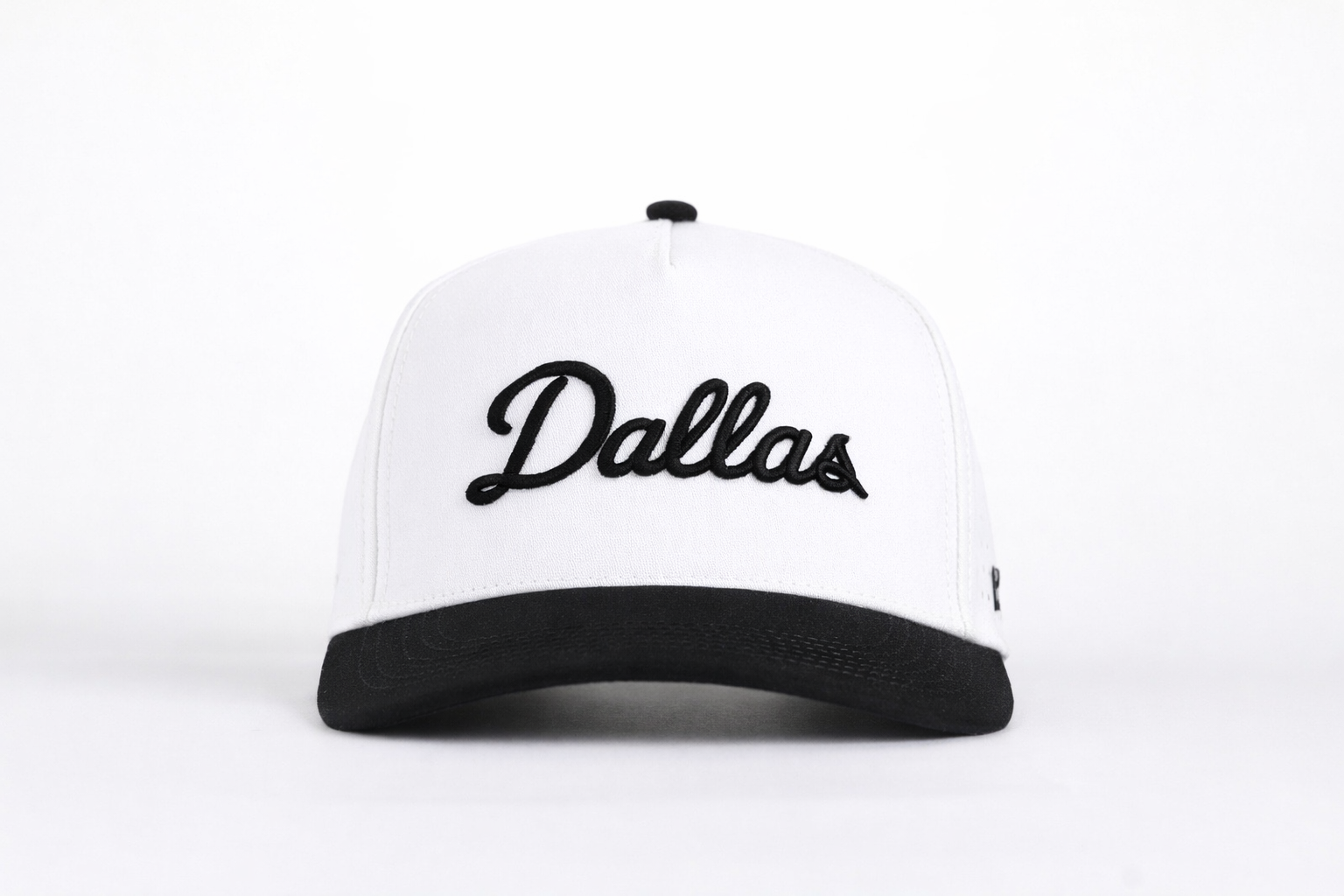 White and black cap with 'Dallas' text on a white background