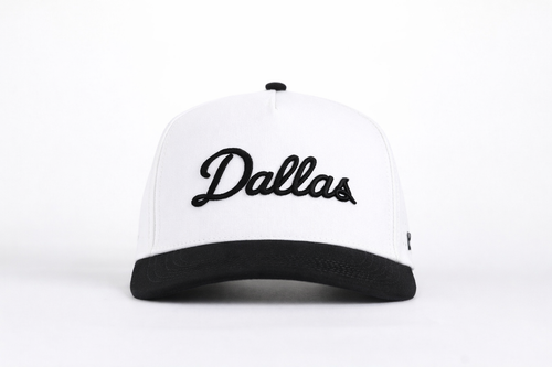 White and black cap with 'Dallas' text on a white background
