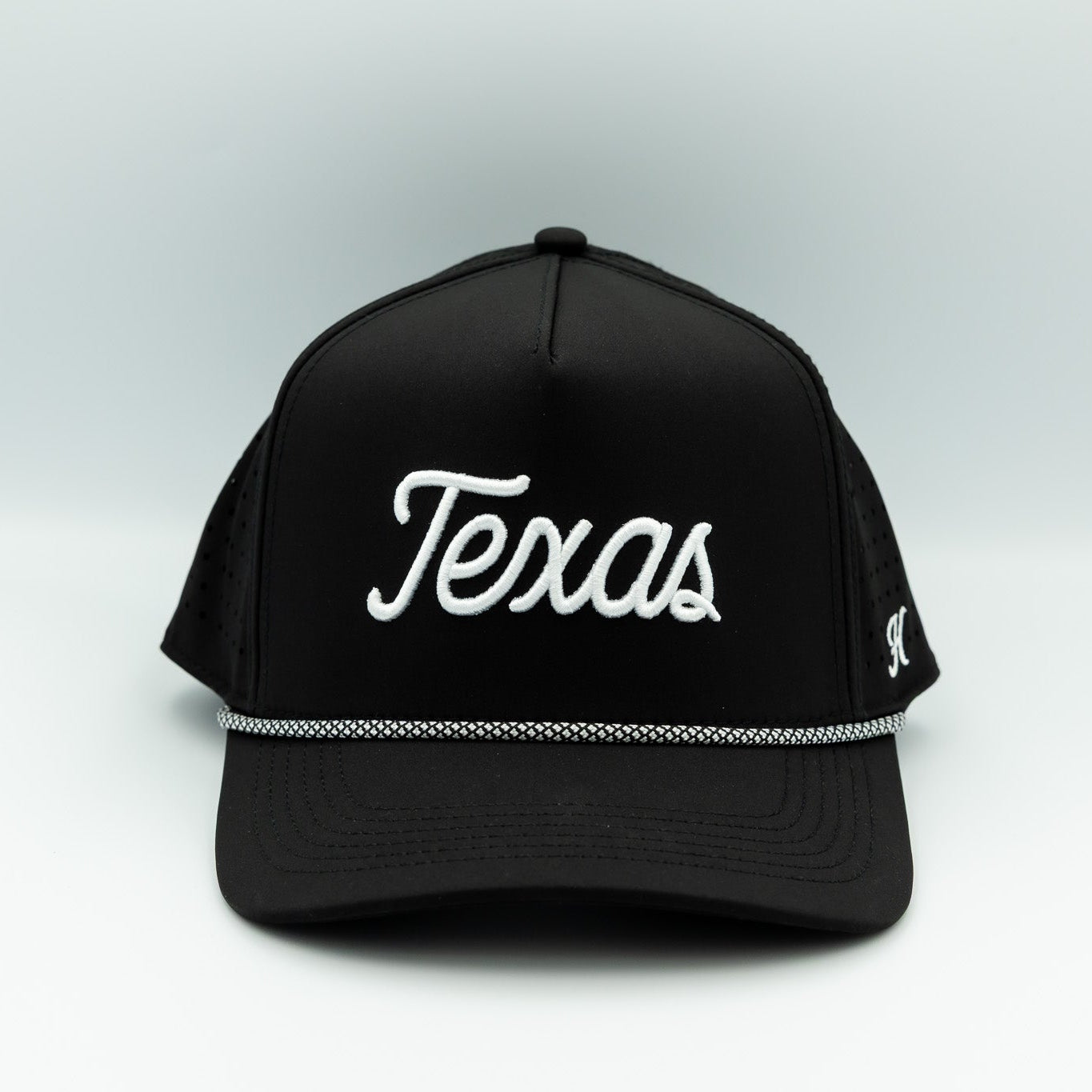 Black cap with 'Texas' printed on it against a white background