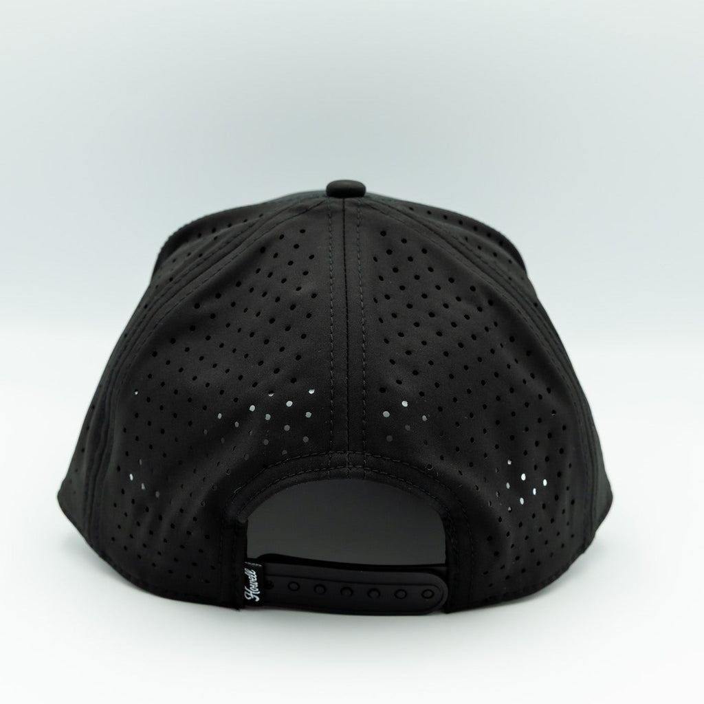 Black cap with perforated design on a white background