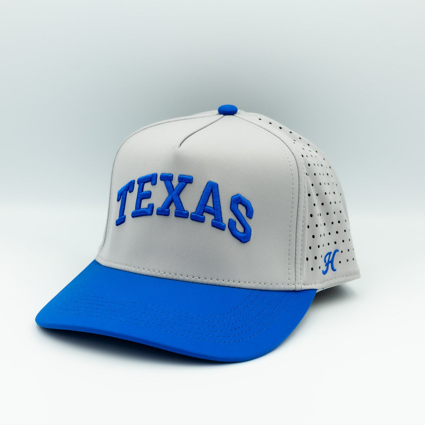 grey and blue cap with 'TEXAS' text on a light gray background