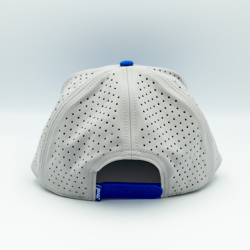 White baseball cap with blue interior on a light gray background