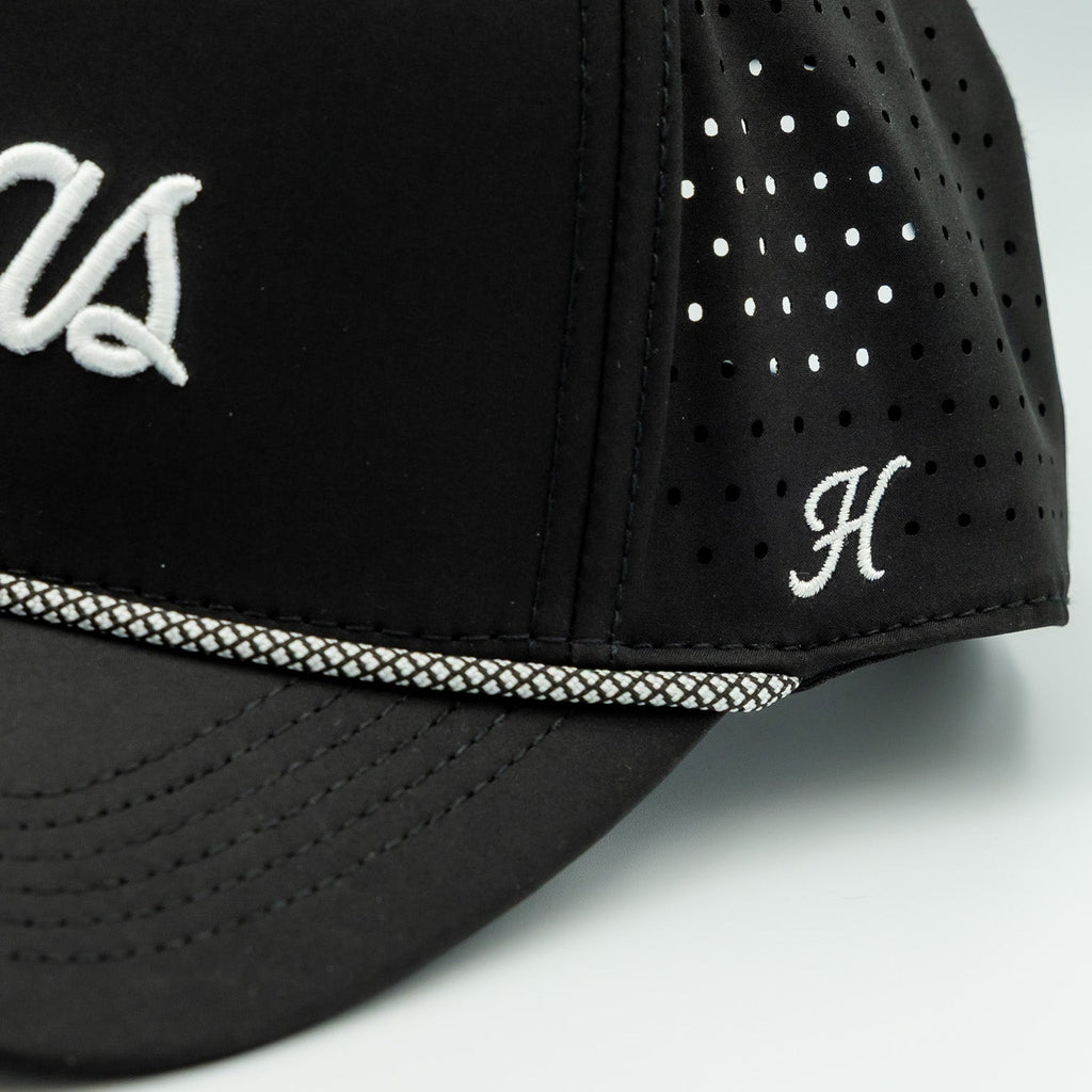 Black cap with white text and logo on a light gray background