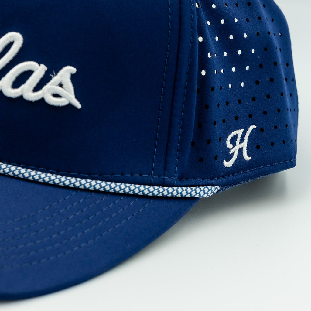 Blue cap with white text and logo on a light gray background